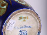 a blue vase with a gold and blue design on it