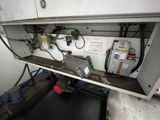 an image of a machine that is working on a piece of metal