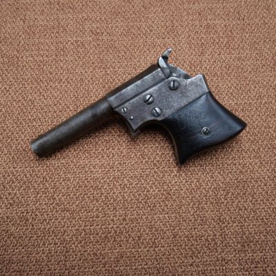 a close up of an old gun on a brown carpet