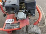 an image of a small engine on a red cart