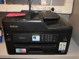 a printer that is sitting on a desk next to a window