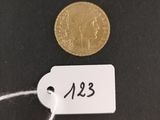 a close up of a coin on a string with a price tag