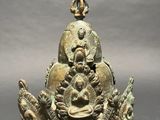 an image of a bronze statue of a person holding a baby