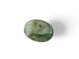 a close up of a green stone on a white surface