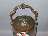 a silver vase with a pink flower painted on it