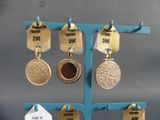 a display of medals and tags on a blue stand