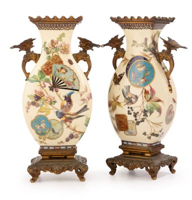 pair of vases with birds and flowers painted on them on stands