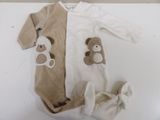 a teddy bear on a tan and white onesuit