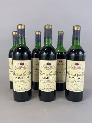 four bottles of wine are lined up on a table