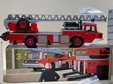 a toy fire truck with a ladder on top of it