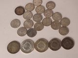 a lot of coins sitting on a white surface