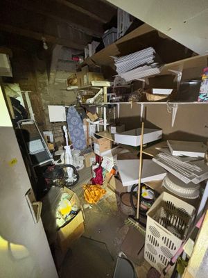 a messy room with a lot of clutter on the floor