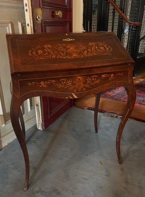 a small desk with a drawer on top of it