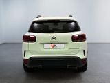 the rear end of a white citrole suv parked in a room