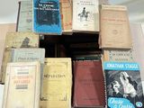 many books stacked on top of each other on a table