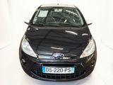 a black car that is parked in a white room