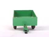 a small green toy truck with wheels on a white surface