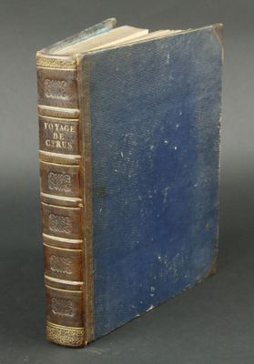 an old book sitting on top of a table next to a black table
