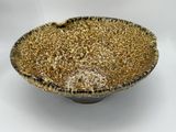 an image of a brown and black bowl sitting on top of a white table