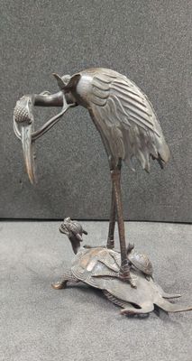 a statue of a bird with a fish in it ' s mouth