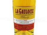 a close up of a bottle of alcohol on a white surface