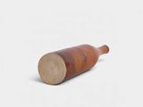a wooden bottle that is sitting on a white surface