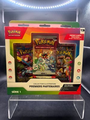La boîte contient un jeu de cartes Pokémon et un étui de rangement.