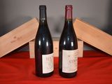 two bottles of wine sitting next to each other on a table