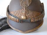 a brown helmet with a gold decoration on it