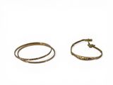 two gold bracelets on a white background with a white background
