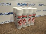 four cans of alcohol are sitting on a table in front of a sign