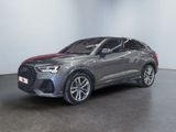 a grey audi qx parked in a room with a black floor