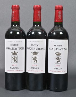 three bottles of red wine sitting next to each other on a table