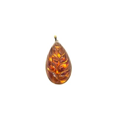 an image of a glass pendant with a leaf design on it