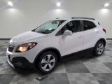 the white buick suv is parked on a checkered tile floor