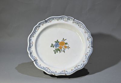 une assiette blanche décorée de fleurs bleues et jaunes