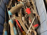 many different tools in a blue bin on the floor