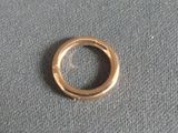 a small gold ring on a gray surface
