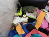 a pile of shoes and bags in the back of a car