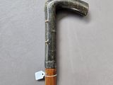 an old cane with a tag attached to it