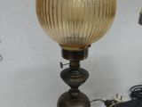 a lamp that is sitting on a table next to a teddy bear