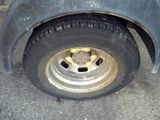 a close up of a flat tire with a banana on it