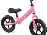 the small pink bike is sitting on a white surface