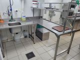 a kitchen with a sink, stove, and other appliances