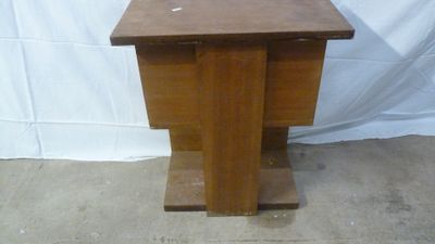 a small wooden table with a vase on top of it