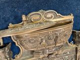 a very old metal object that is sitting on a blue surface