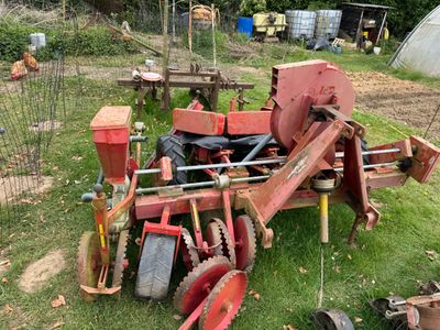 a red tractor that is sitting in the grass