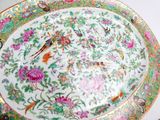 a plate with a bird and flowers on it on a table
