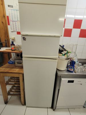 a refrigerator and a dishwasher in a small kitchen