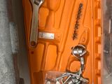an orange tool case with tools in it on a table